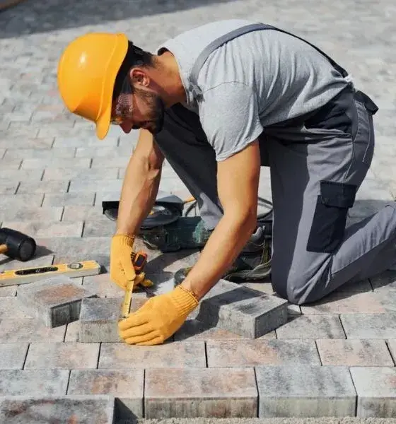 Landscaper installing paver patio in Atlanta GA