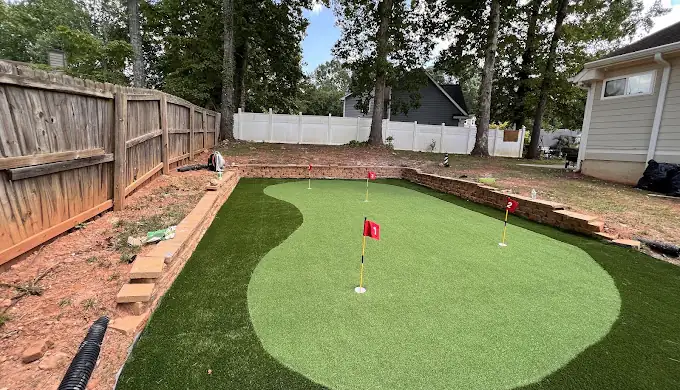 Newly installed backyard artificial putting green with flags in Atlanta GA