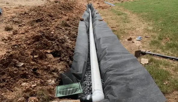 French drain installation with gravel and fabric for yard drainage in Atlanta GA