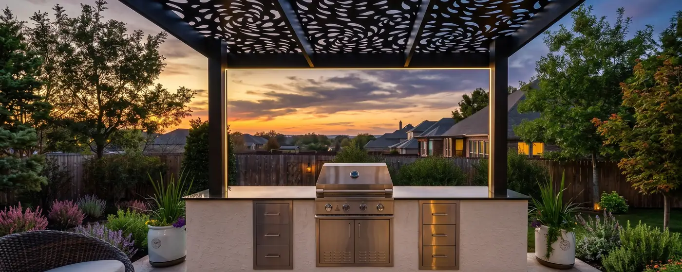 Modern outdoor kitchen with built-in grill under a laser-cut pergola at sunset in Atlanta GA