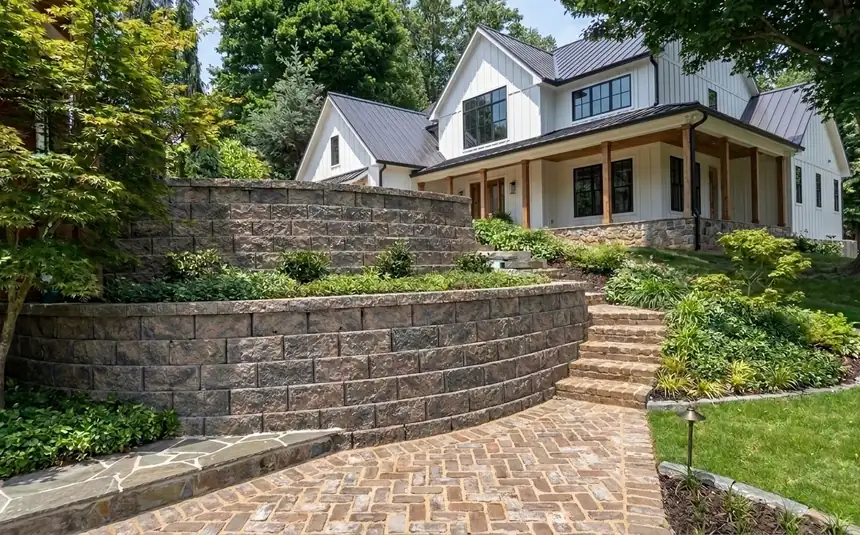 Tiered stone retaining wall with herringbone paver walkway in Atlanta GA